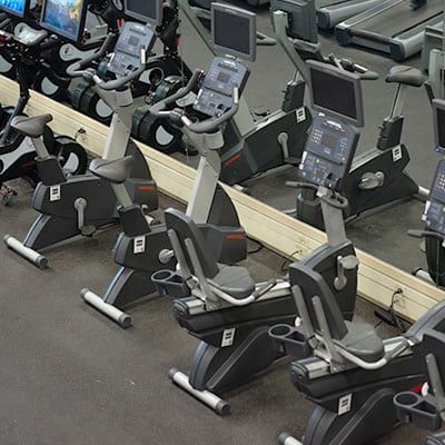 row of neatly placed cardio machines in a row