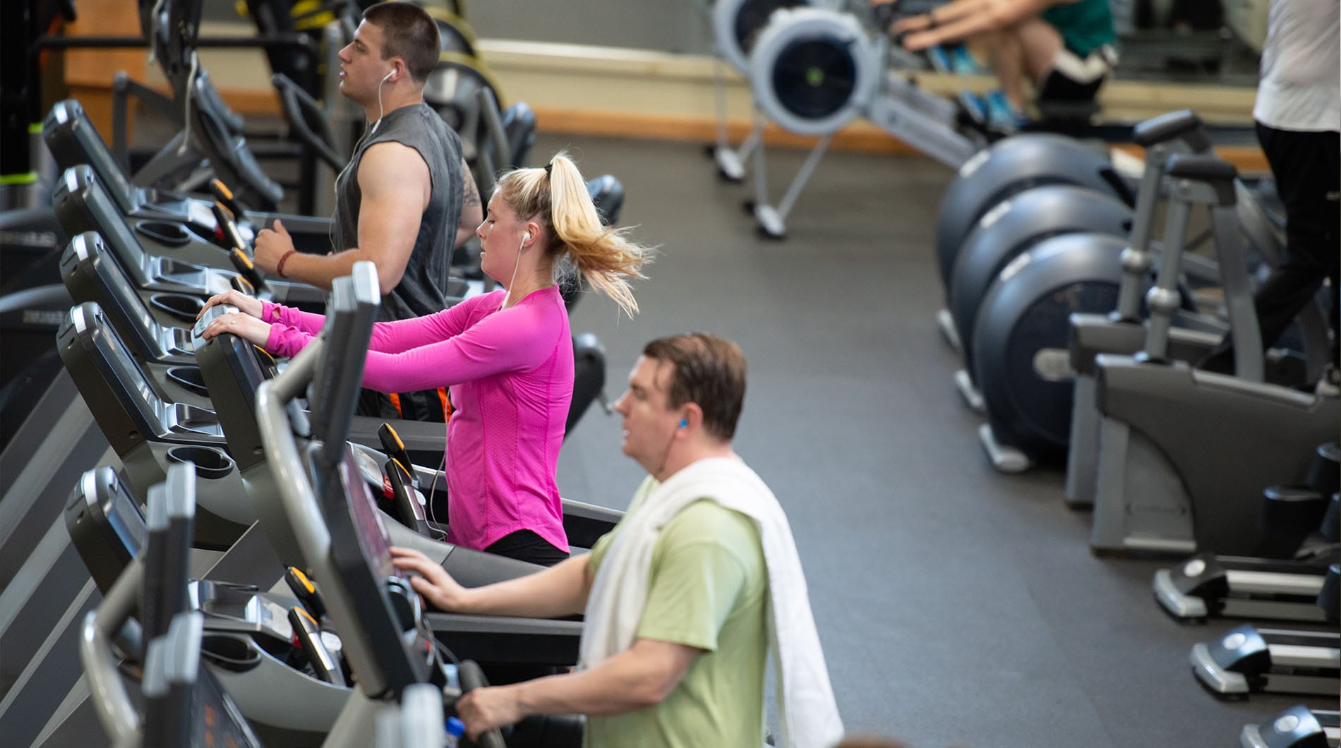 group of fit people running on treadmills