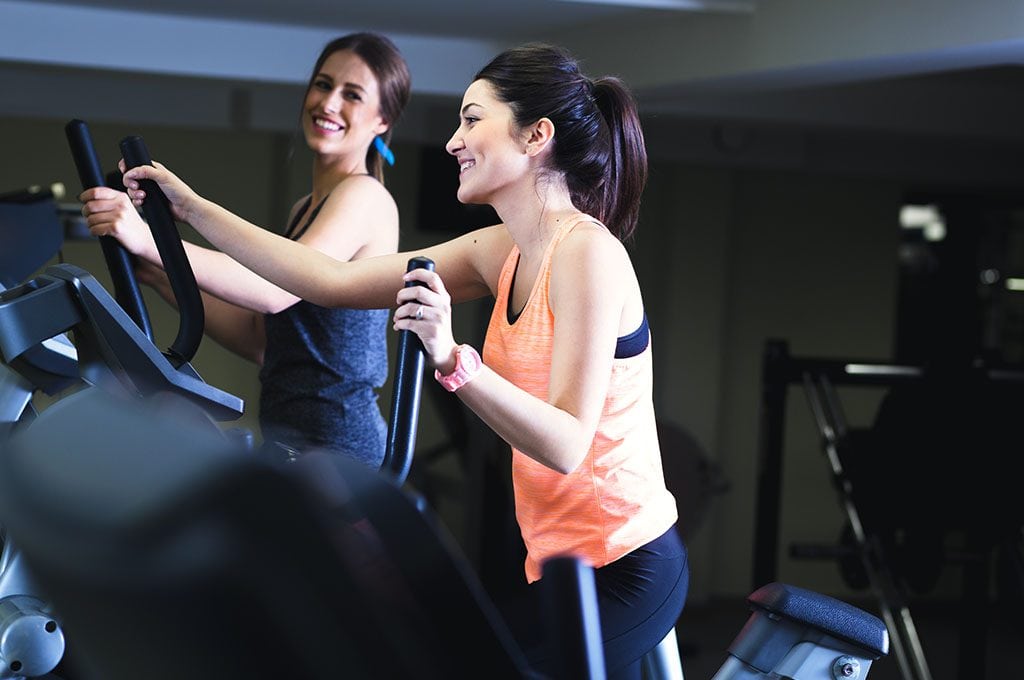 2 women working out on stair climber
