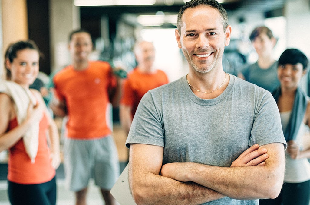 man standing in front of friends after a gym workout