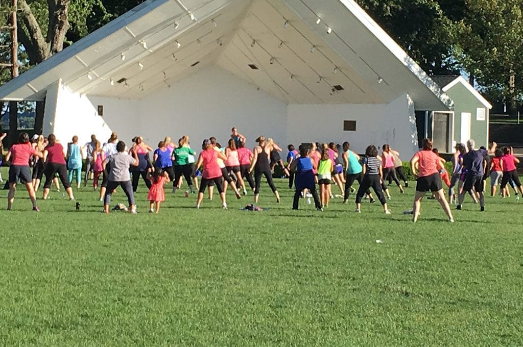 outdoor fitness class in spacious field at best athletic club near me