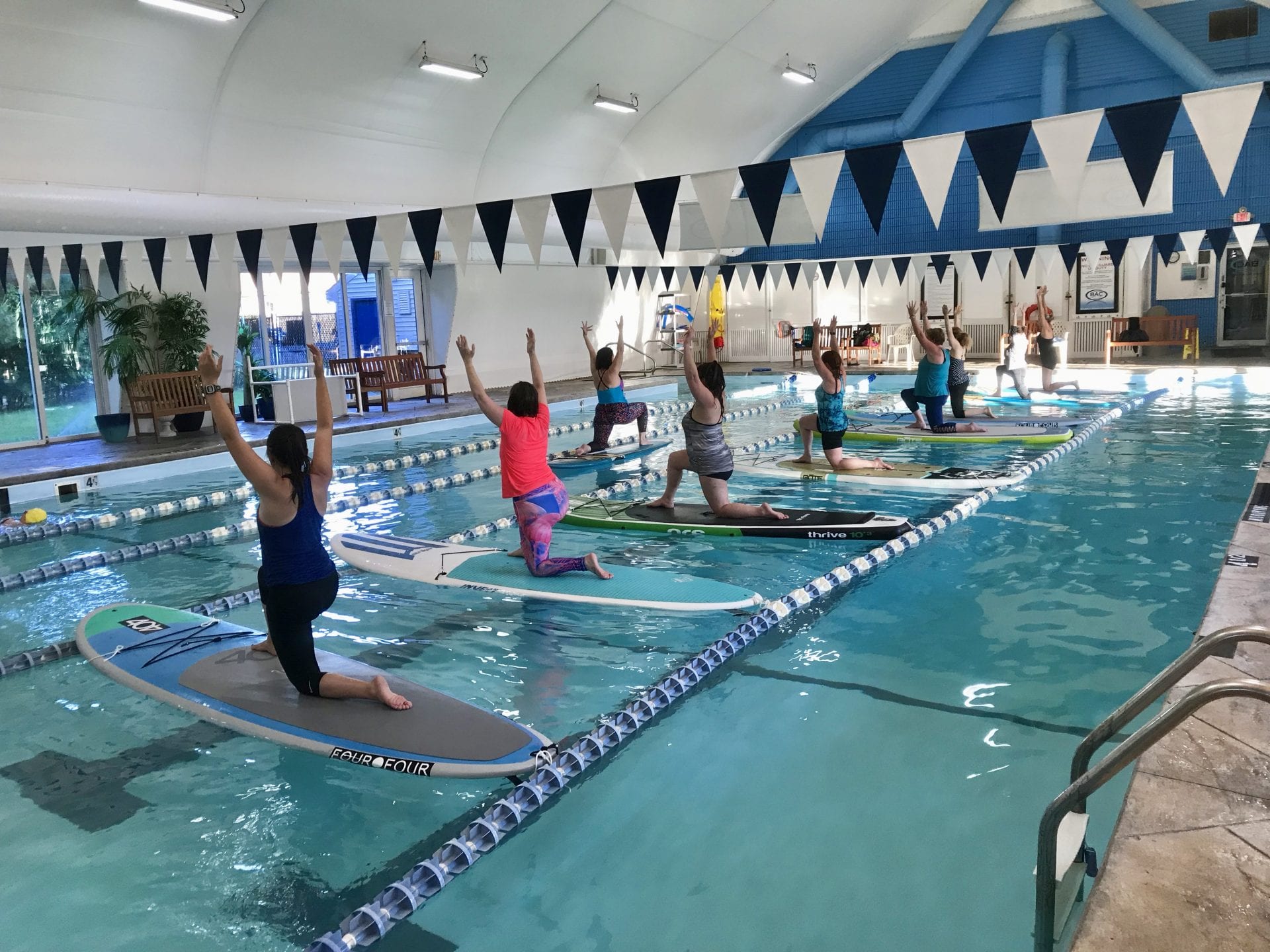 gym members performing water yoga at beverly athletic club