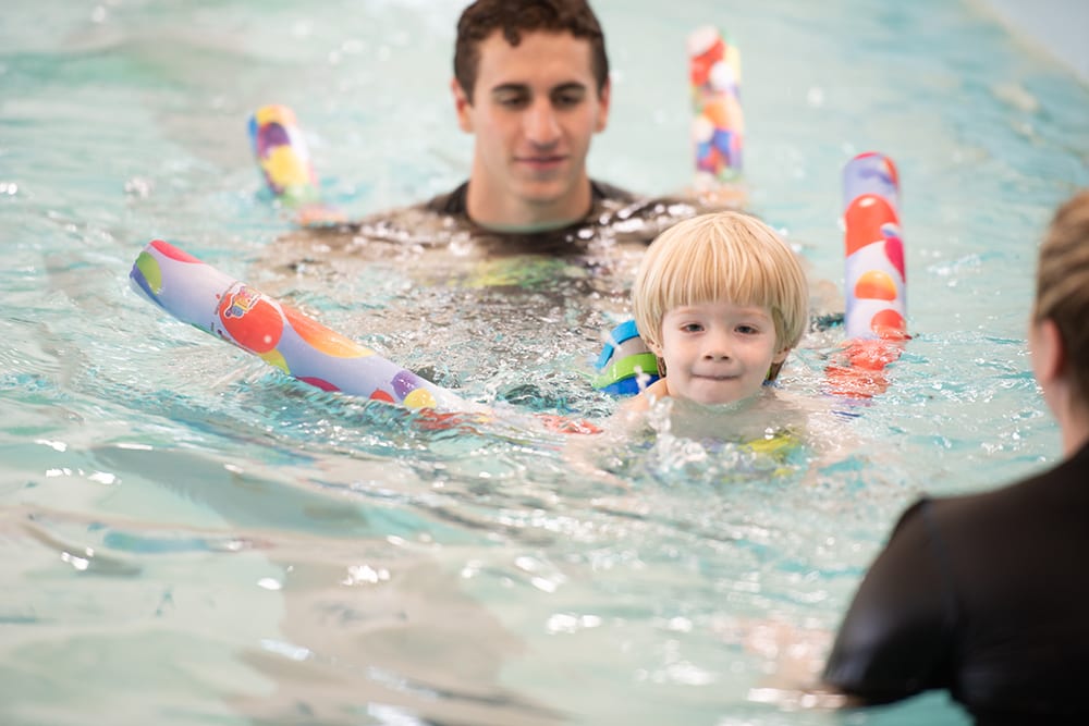 boy receiving swim instruction from beverly athletic club swim teacher