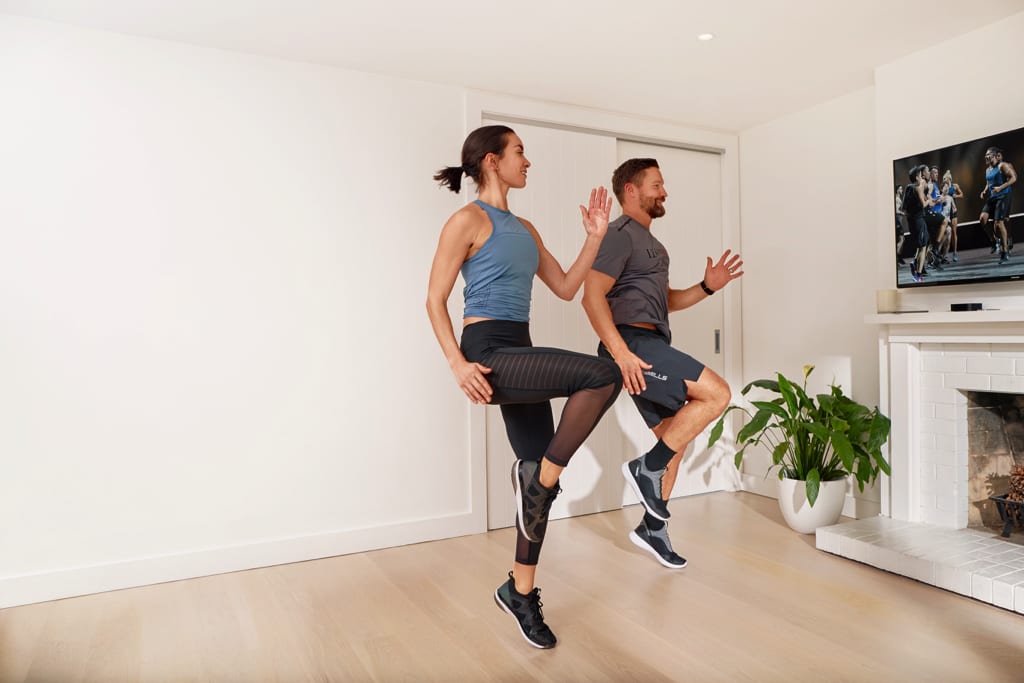 couple working out to les mills on demand virtual classes from home